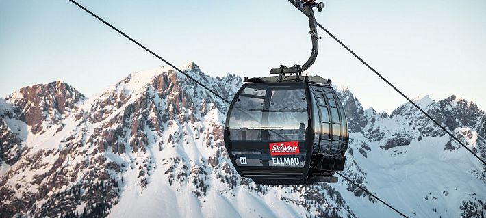 Schwarze Gondel Hartkaiserbahn in Ellmau mit dem verschneiten Wilden Kaiser im Hintergrund