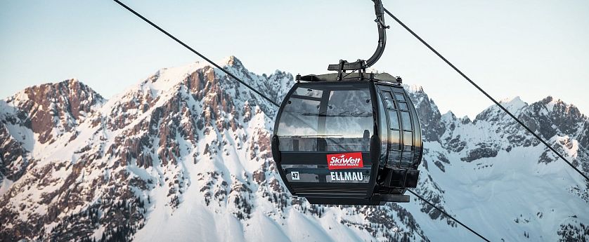 Schwarze Gondel Hartkaiserbahn in Ellmau mit dem verschneiten Wilden Kaiser im Hintergrund