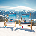 Twee strandstoelen staan in de sneeuw met een uitzicht op besneeuwde bergen onder een heldere blauwe lucht. Het is een zonnige winterdag.