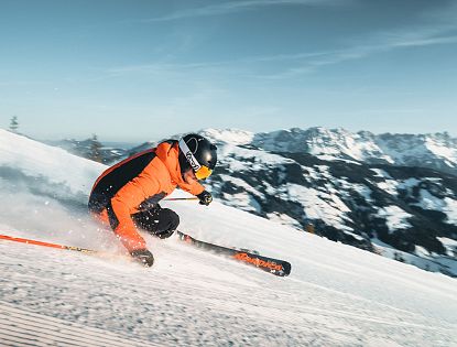 Skifahrer auf Kandler Abfahrt in SkiWelt Westendorf Brixen mit Blick auf Wilden Kaiser