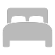 Eine minimalistische Darstellung eines Bettes in Grau. Es hat zwei Kopfkissen und ist vorne mit einer runden Kante gestaltet, ideal für stilvolle Schlafzimmer.